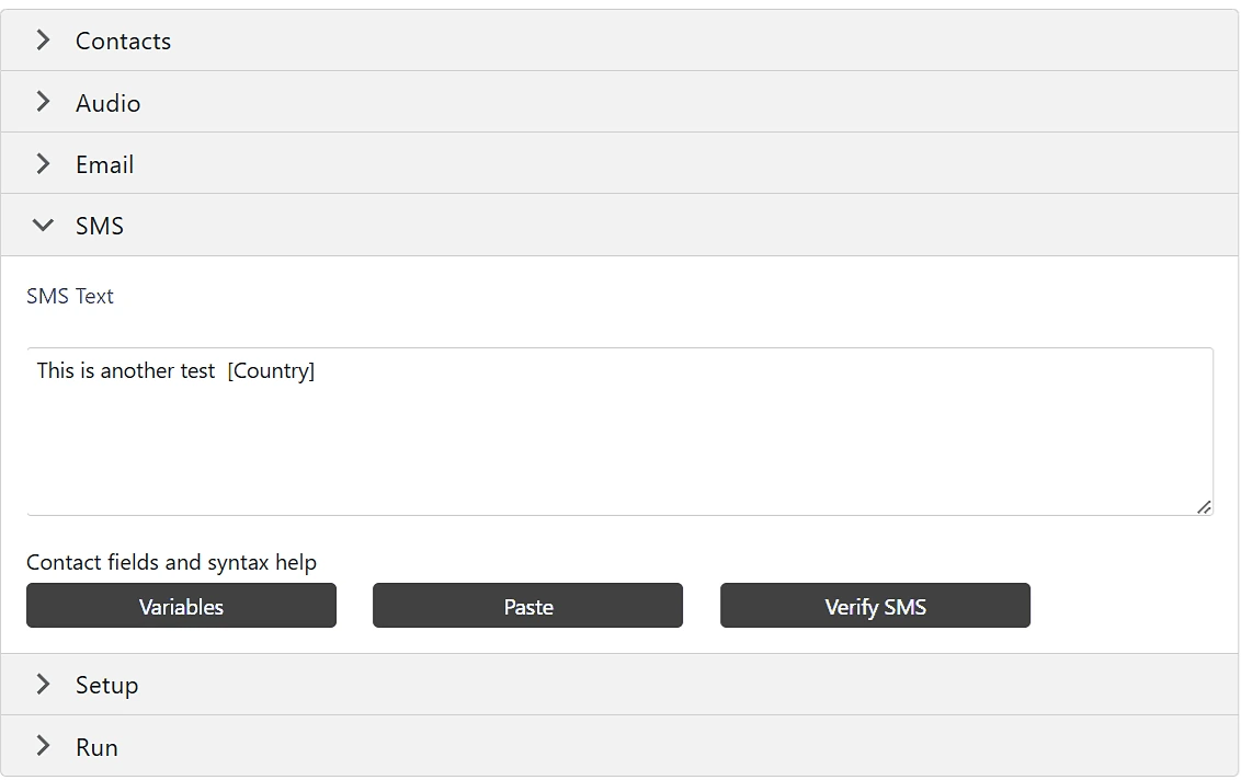SMS tab of a campaign with a text message that includes the Country contact field and Variables, Paste and Verify SMS buttons
